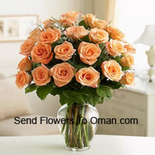 24 персиковых розы с папоротниками в стеклянной вазе