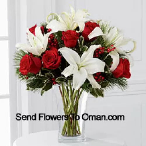 Fulfill their dreams for a glimpse of the season's inspired beauty. Rich red roses dazzle and delight when arranged with snowy white Oriental lilies accented with assorted holiday greens and variegated holly stems in a clear, sculpted glass vase. This bouquet offers them a warm wish for a lovely holiday season they will always hold dear. (Please Note That We Reserve The Right To Substitute Any Product With A Suitable Product Of Equal Value In Case Of Non-Availability Of A Certain Product)