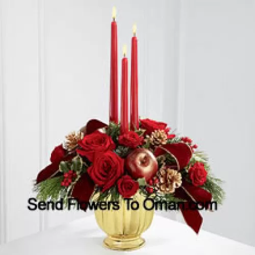 The grandeur and rich beauty of the Christmas season are highlighted with each crimson bloom. Bright red roses and spray roses are arranged in a designer gold container amongst variegated holly and assorted holiday greens. Accented with artificial apples, gold pinecones and gold-edged burgundy ribbon, this gorgeous centerpiece displays three red taper candles to create the perfect atmosphere for their holiday celebration.  (Please Note That We Reserve The Right To Substitute Any Product With A Suitable Product Of Equal Value In Case Of Non-Availability Of A Certain Product)